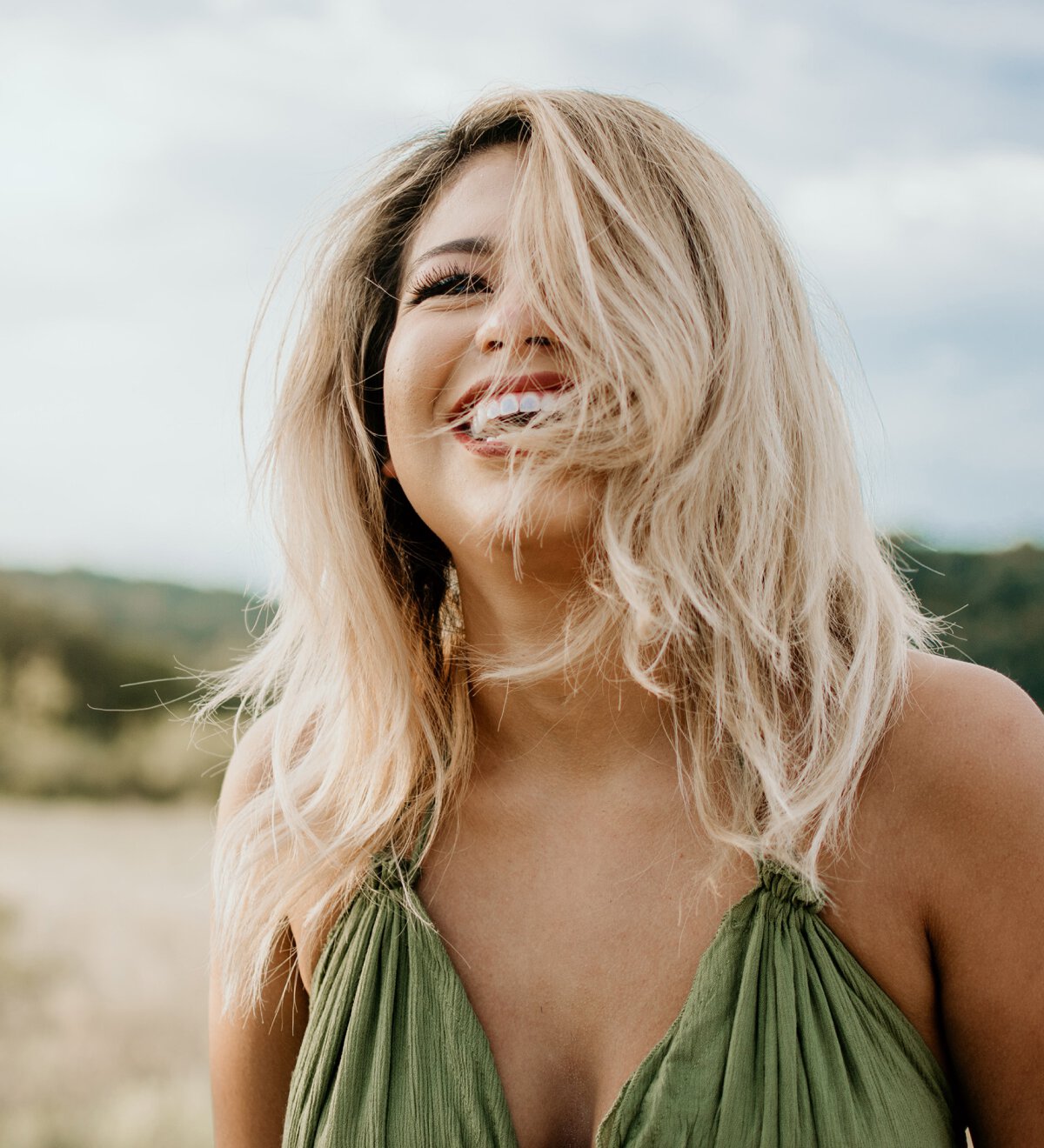 Blonde Haired Woman laughing on beach